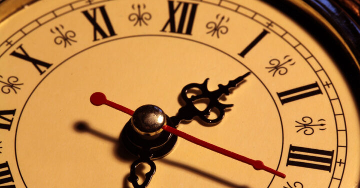 Clock with roman numerals, hands, and second hand