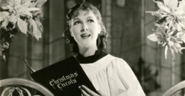 Young woman in the 1940s in choir robe singing Christmas hymns