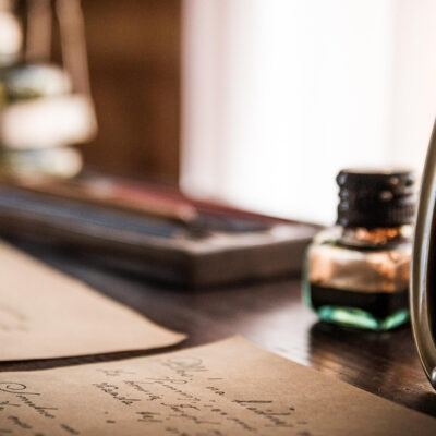 Vintage desk scene with framed photograph, ink, and paper