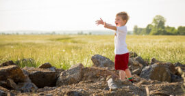 Little boy reaching out his arms