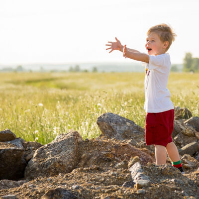 Little boy reaching out his arms