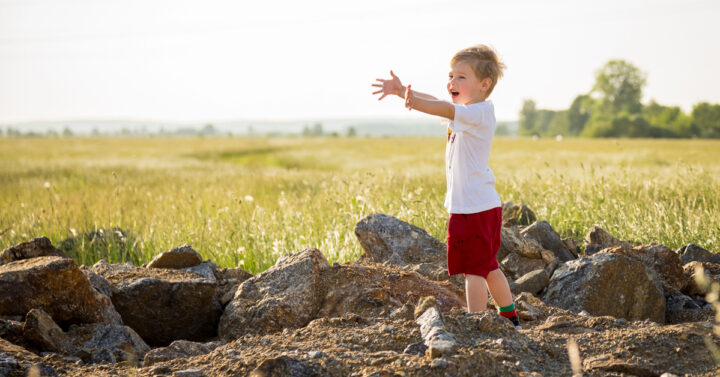 Little boy reaching out his arms