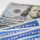 Social security cards and piles of 100 dollar bills