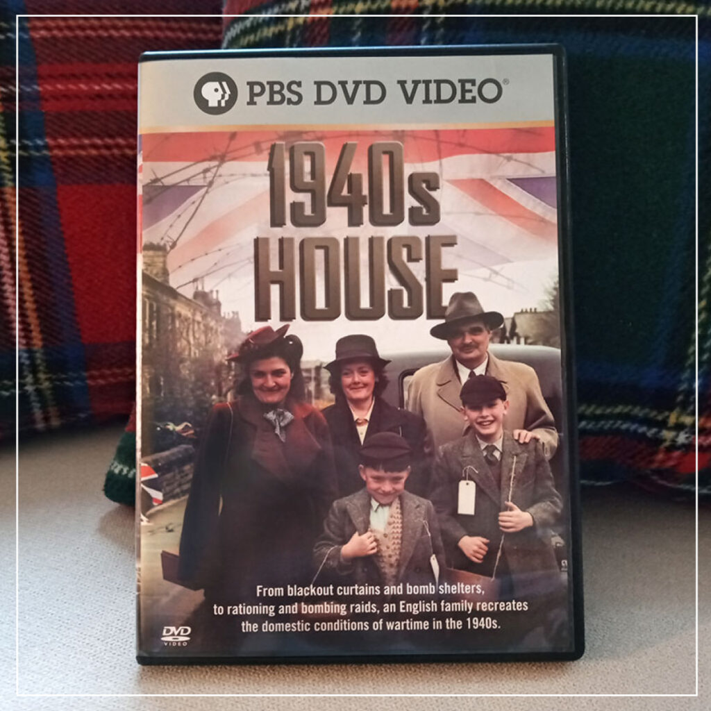 Copy of 1940s House DVD on couch with plaid pillows behind it