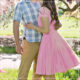 Young woman in pink dress with young main in plaid shirt embracing
