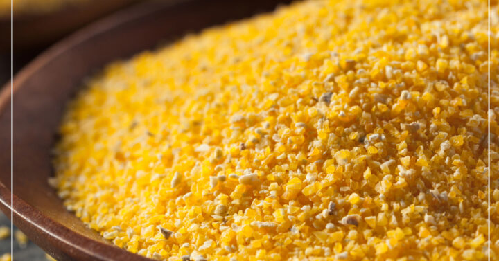Organic corn meal in a brown wood bowl
