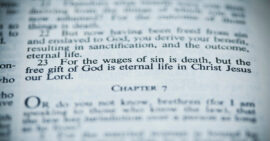Bible open to Romans 6:23