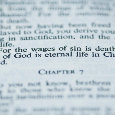 Bible open to Romans 6:23